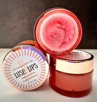Pink lip scrub in a clear container with a visible brand label on a neutral background